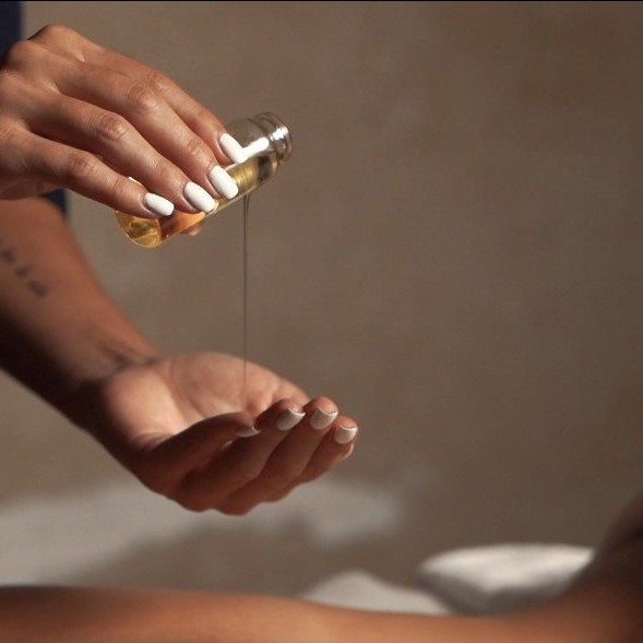 Therapist providing a relaxing spa treatment with essential oils at Spa Villa